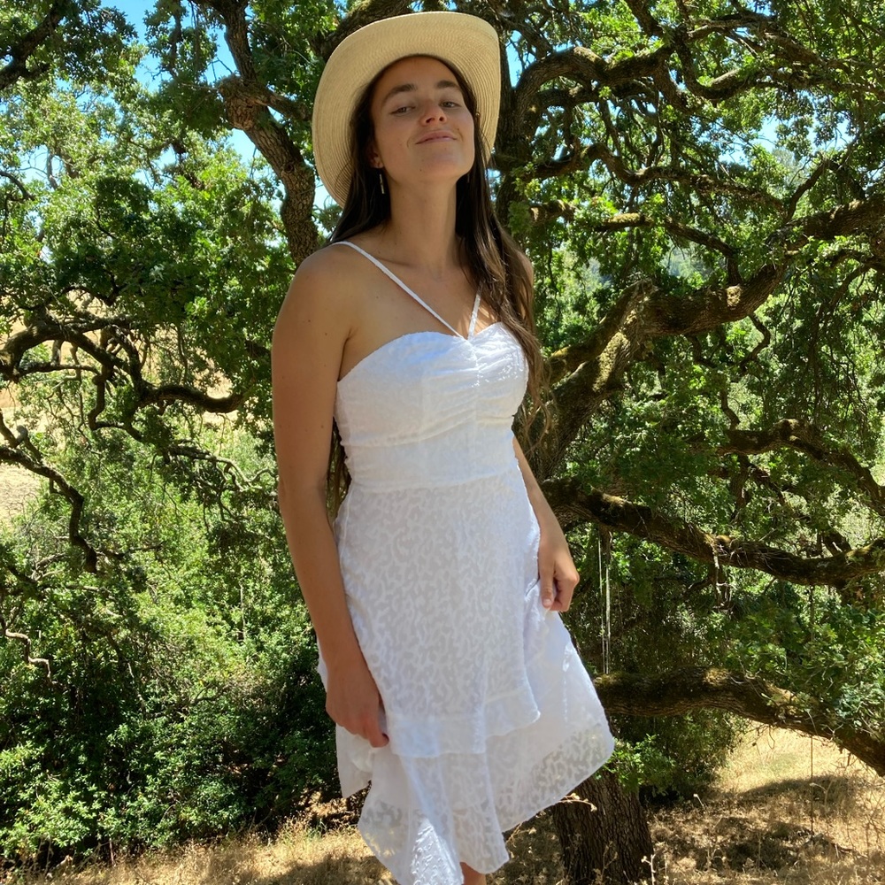 Bebe! Flirty white eyelet sundress perfect for a date night or concert!